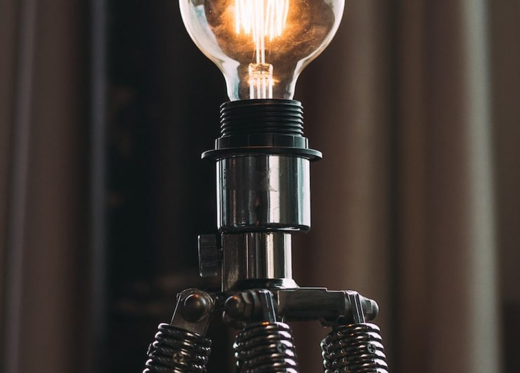 closeup-shot-high-voltage-lightbulb-tripod-studio_181624-3495