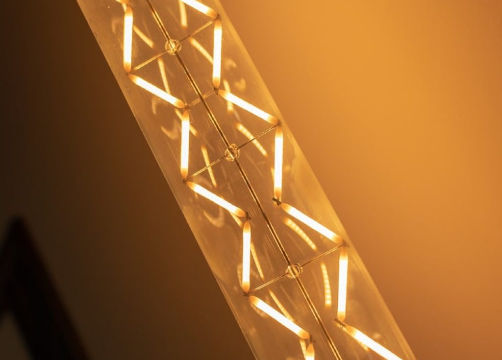 vintage-edison-long-tube-spiral-filament-bulb-wall-with-dark-background_251763-130